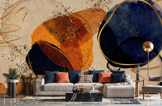 Abstract cosmic wall mural with orange and navy circular forms, shown in modern living room with grey sectional sofa
