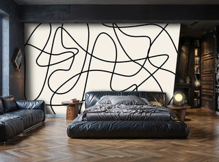 abstract line art wallpaper with flowing black curves on beige, in modern bedroom with leather furniture