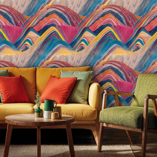 Abstract mountain wallpaper with colorful wavy layers in a mid-century living room with mustard sofa