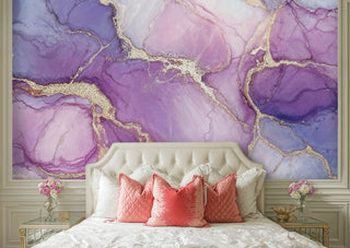 Amethyst marble wall mural with gold accents in a glam bedroom with tufted headboard and coral pillows