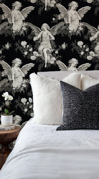 Angel and floral wallpaper featuring winged figures among peonies, displayed in bedroom with white bedding