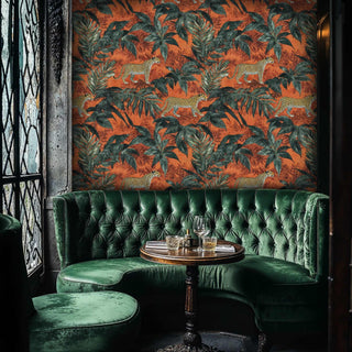 Animal print wallpaper showcasing leopards in tropical setting, featured in luxury bar area with tufted green banquette