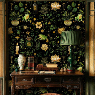 Apothecary themed wallpaper with frogs and candles, featured in classic study with antique desk and green table lamp