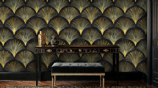 Art Deco fan pattern wallpaper with geometric gold designs on black, shown in sophisticated entryway with ornate bench