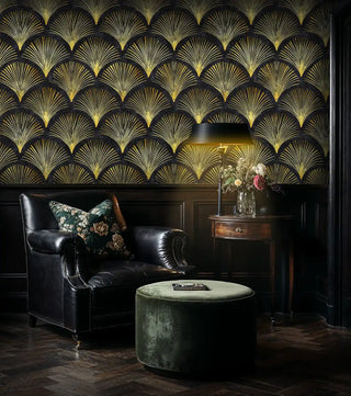 Art Deco fan wallpaper with geometric golden motifs on black background, displayed in luxury study with leather armchair