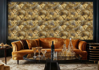 Art Deco scalloped wallpaper in gold featuring geometric fan motifs in stylish lounge with orange velvet sofa