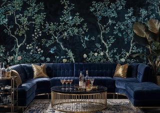 Asian botanical wallpaper with songbirds and branches on navy, featured in sophisticated living room with sectional