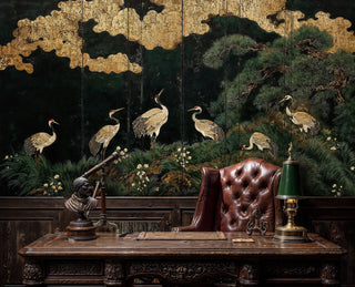 Asian crane wallpaper with pine trees and gold clouds, shown in home office with antique desk