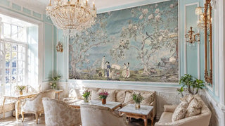 Asian garden wall mural with cherry blossoms and traditional figures in elegant living room with crystal chandelier