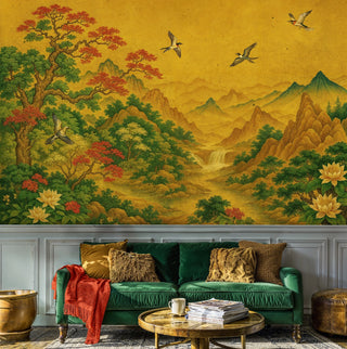 Asian mountain landscape wall mural with golden cranes and autumn foliage, shown in living room with green sofa