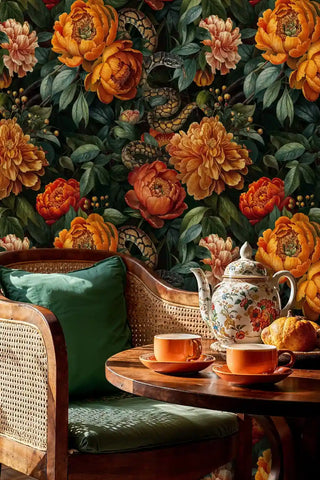 Autumn botanical wallpaper in cozy sitting area with cane chair and orange teacups
