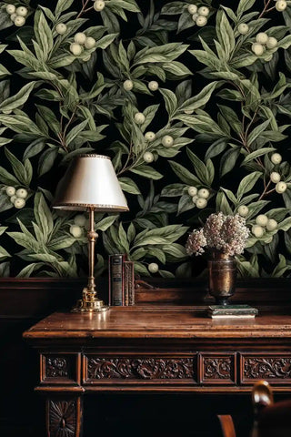 Berry branch wallpaper with botanical pattern in black and beige, shown in classic study with ornate wooden desk