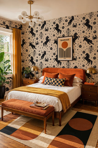 Black and beige animal pattern wallpaper with celestial motifs, in a bedroom with rust upholstered bed