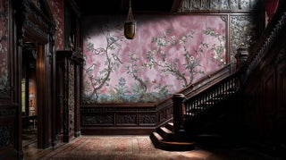 Blooming birds wall mural with songbirds on flowering branches in pink tones, shown in ornate entryway