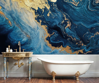Blue gold fluid marble wall mural with organic textures in a vintage bathroom with ornate brass washstand and tub