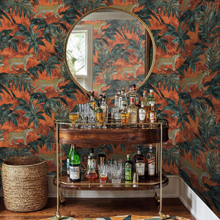 Bold tropical wallpaper with prowling leopards and palm leaves, styled in sophisticated space with brass bar cart