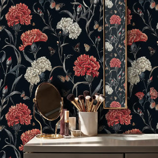 Botanical carnation wallpaper featuring coral blooms on navy background in modern bathroom with brass mirror