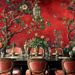 Botanical chinoiserie wallpaper with birds and flowers shown in elegant dining room with brass chandelier