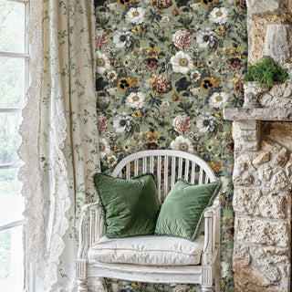 Botanical floral wallpaper with butterflies and mixed blooms, shown in cozy reading nook with white wooden chair