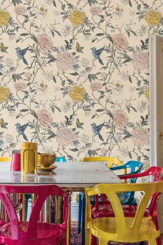 Botanical floral wallpaper with songbirds and butterflies, in a dining room with colorful chairs