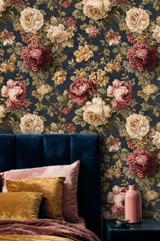 botanical garden wallpaper featuring detailed blooms in navy and gold, displayed in bedroom with velvet headboard