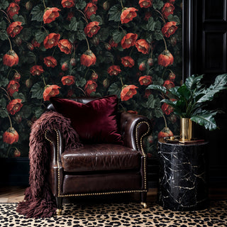 Botanical hellebore wallpaper with coral flowers displayed in sophisticated study with leather armchair and marble table