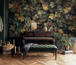 Botanical leaf wallpaper featuring autumn foliage in elegant room with antique piano and green bench