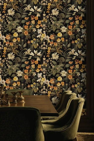 Botanical meadow wallpaper with autumn wildflowers and foliage, shown in sophisticated dining room with green velvet chairs