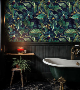 Botanical orchid wall mural with golden accents and lush foliage, in vintage bathroom with green clawfoot tub