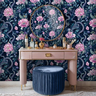 Botanical serpent wallpaper featuring pink florals and scaled serpents, displayed behind elegant vanity table