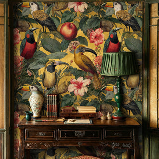 Botanical toucan wallpaper with fruits and blooms, in a vintage study with antique desk and green lamp