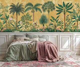 Botanical wall mural featuring lush palm trees and flowering vines, displayed in cozy bedroom with sage green bedding and white wainscoting