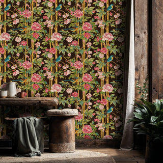 Botanical wallpaper featuring exotic birds and pink flowers on dark background, shown in a rustic dining space