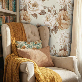 Botanical wallpaper featuring large cream roses and brown stems, displayed in reading nook with mustard throw blanket