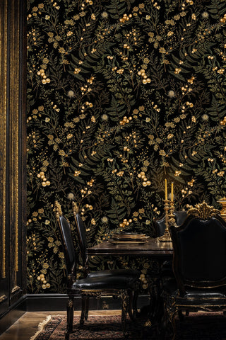 Botanical wallpaper in black and gold with wildflowers, in a formal dining room with leather chairs and candles