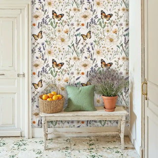 Botanical wallpaper with butterflies and wildflowers in cream tones, displayed in an entryway with vintage bench and terracotta pot