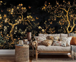 Botanical wallpaper with gold branches and wildflowers displayed in boho living room with wicker furniture