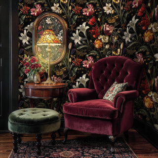 Botanical wallpaper with spotted butterflies and blooms, in a parlor with a burgundy velvet armchair and stained glass lamp