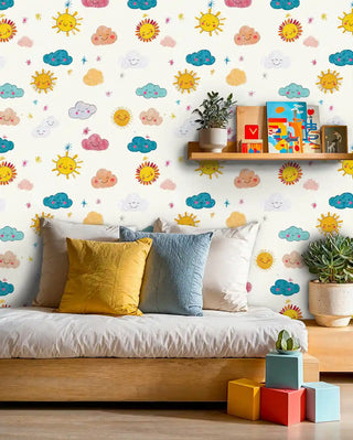 Bright sun and cloud children's wallpaper with smiling elements, shown in modern kids room with wooden daybed