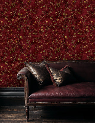 Burgundy botanical wallpaper with scrolling vines, styled in sophisticated living room with decorative pillows