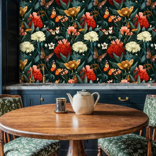 Butterfly botanical wallpaper with monarchs and red, ivory flowers on dark green, above a marble counter with teapot