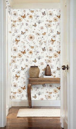 Butterfly garden wallpaper featuring delicate wildflowers and butterflies in cream tones, shown in entryway with wooden console
