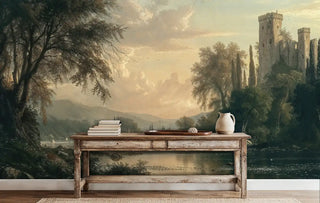 Castle landscape wall mural featuring ancient towers, river valley, and golden sky, displayed behind rustic console table