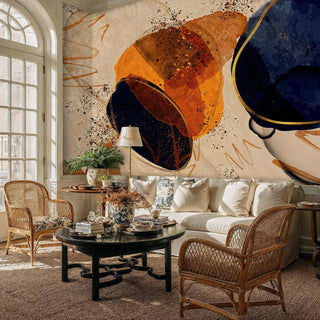 Celestial abstract wallpaper featuring amber and blue orbital shapes, displayed in elegant living room with rattan chairs