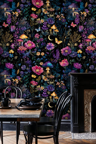 Celestial garden wallpaper featuring vibrant florals on black, in sophisticated dining room with fireplace