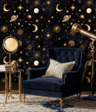 Celestial night sky wallpaper with gold accents displayed in luxury room with navy velvet armchair