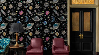 Celestial wallpaper featuring diamond-encrusted space elements, displayed in elegant sitting room with leather chairs