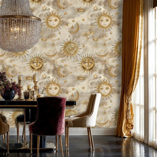 Celestial wallpaper featuring golden suns, moons and stars on beige background, shown in elegant dining room with crystal chandelier