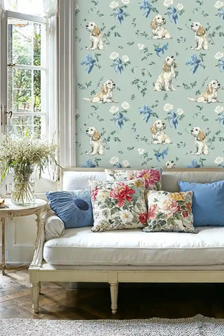 Charming spaniel wallpaper with floral elements on sage background, shown in living room with white settee