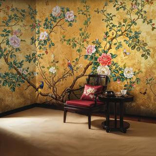 Chinoiserie bird and bloom wallpaper in sophisticated study with red velvet chair and side table